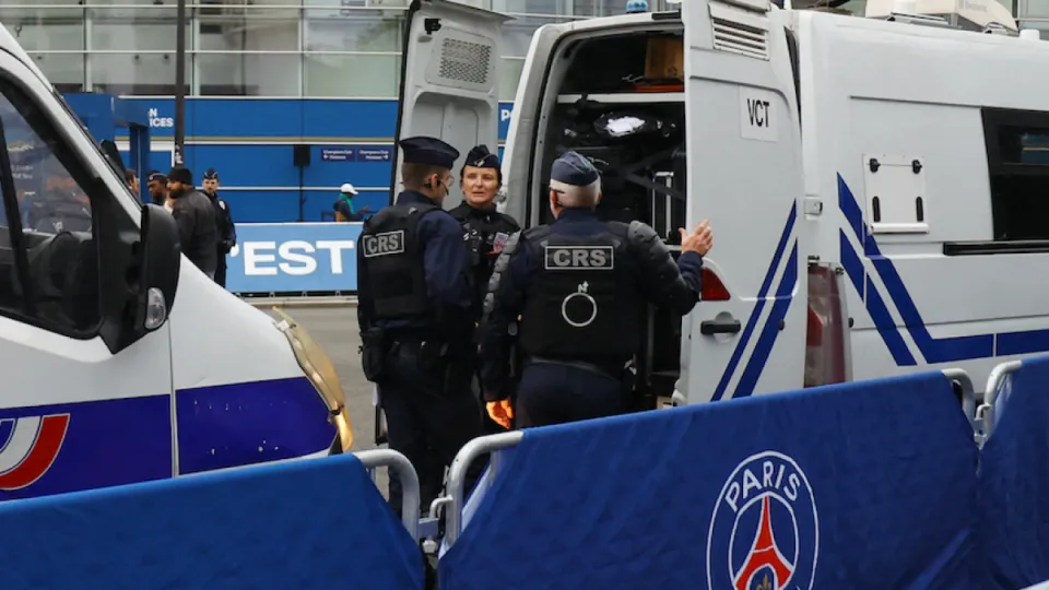 Editorial photograph illustrating PSG and Barcelona fans split over politics in football amid French unrest