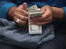 Editorial photograph illustrating Iraq Devalues Dinar Amid Cash Crisis