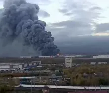 Editorial photograph illustrating Fire burns for hours at Ozon logistics center after St. Petersburg drone attack
