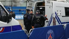 Editorial photograph illustrating PSG and Barcelona fans split over politics in football amid French unrest