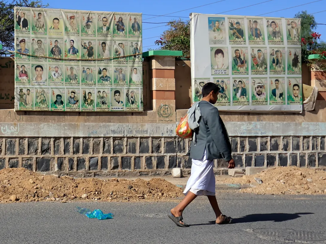 Editorial photograph illustrating Saudi brands Houthi airport strikes war crimes; US warns on aviation safety